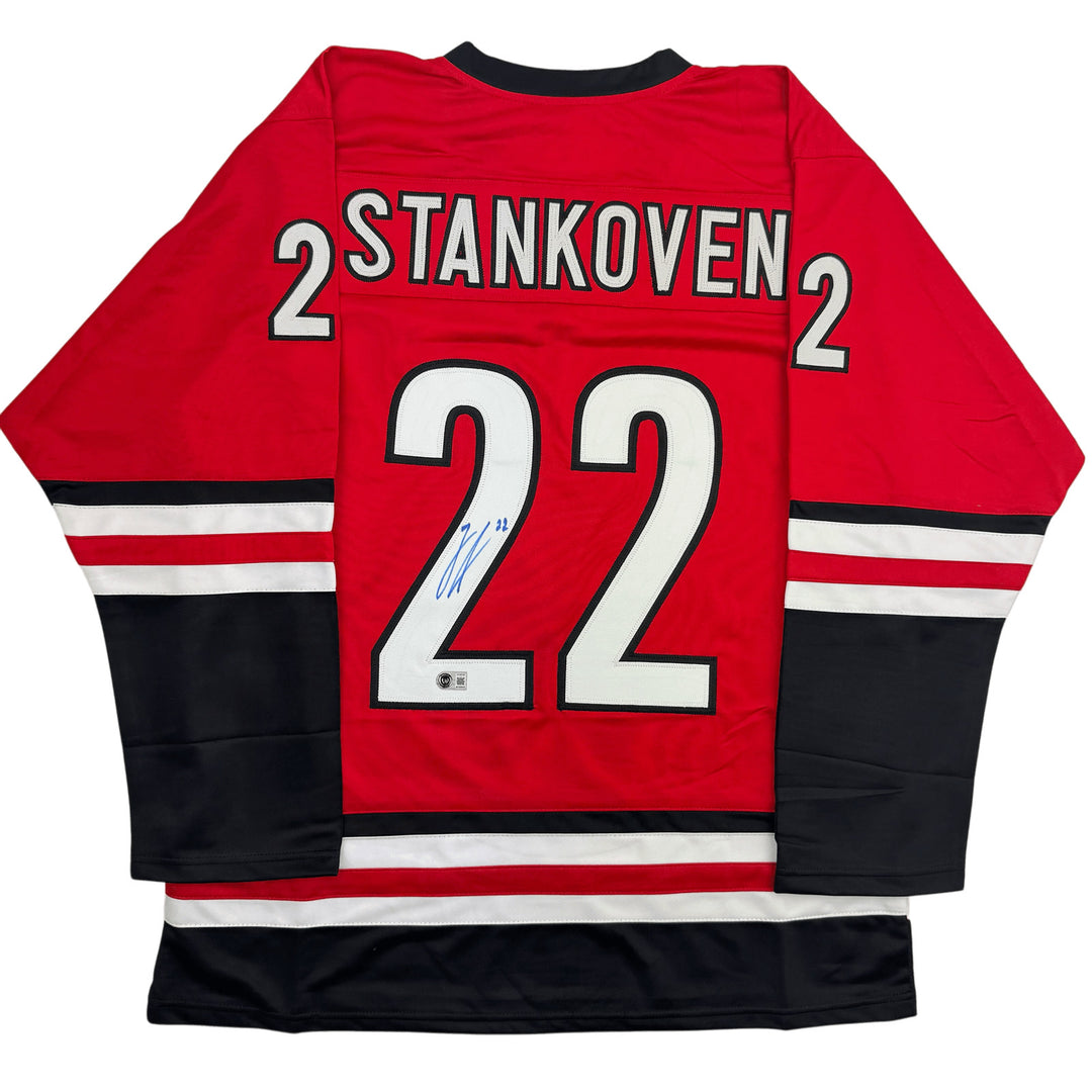 Autographed/Signed Logan Stankoven Carolina Red Jersey Beckett BAS COA