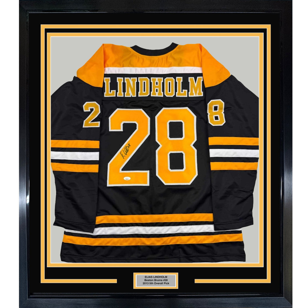 Framed Autographed/Signed Elias Lindholm 35x39 Black Hockey Jersey JSA COA