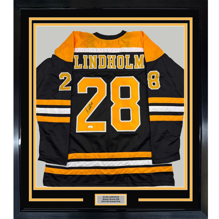 Framed Autographed/Signed Elias Lindholm 35x39 Black Hockey Jersey JSA COA