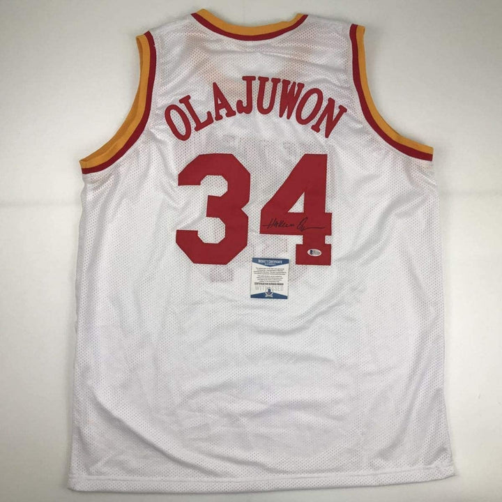 Autographed/Signed Hakeem Olajuwon Houston White Jersey Beckett BAS COA