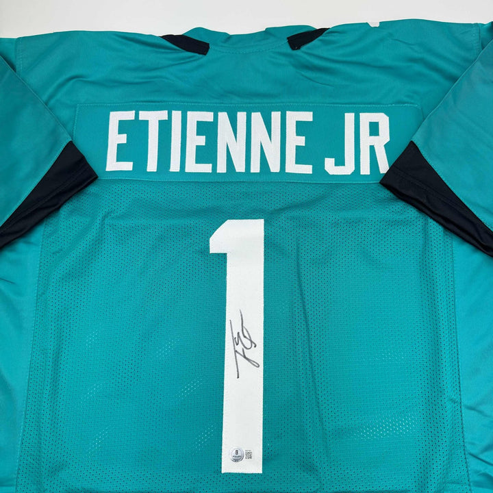 Autographed/Signed Travis Etienne Jr. Jacksonville Teal Jersey Beckett COA