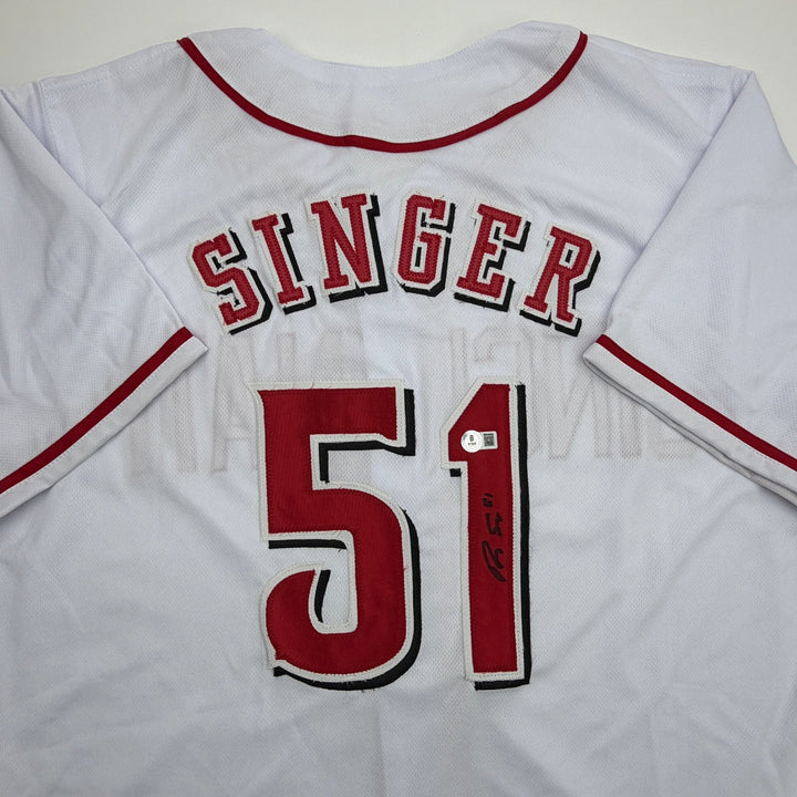 Autographed/Signed Brady Singer Cincinnati White Baseball Jersey Beckett BAS COA