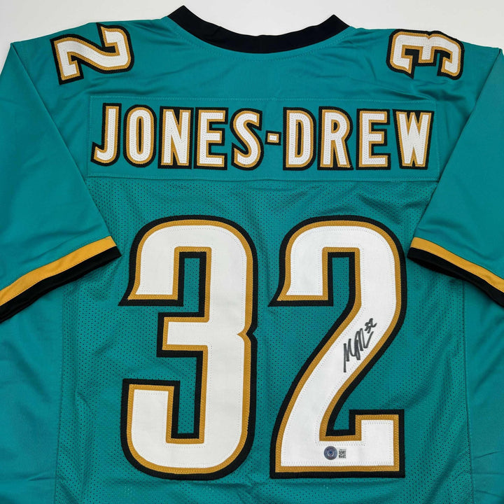 Autographed/Signed Maurice Jones-Drew Jacksonville Teal Jersey BAS COA