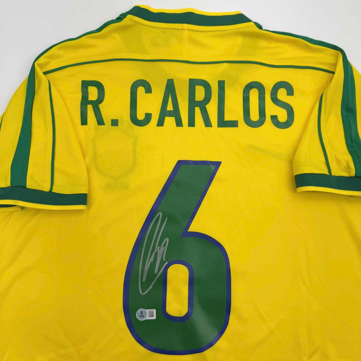Autographed/Signed Roberto Carlos Brazil Yellow Jersey Beckett BAS COA