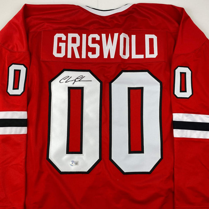 Autographed/Signed Chevy Chase Clark Griswold Vacation Red Jersey Beckett COA