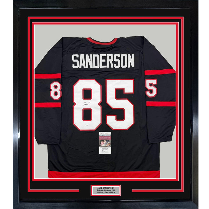 Framed Autographed/Signed Jake Sanderson 35x39 Ottawa Black Jersey JSA COA