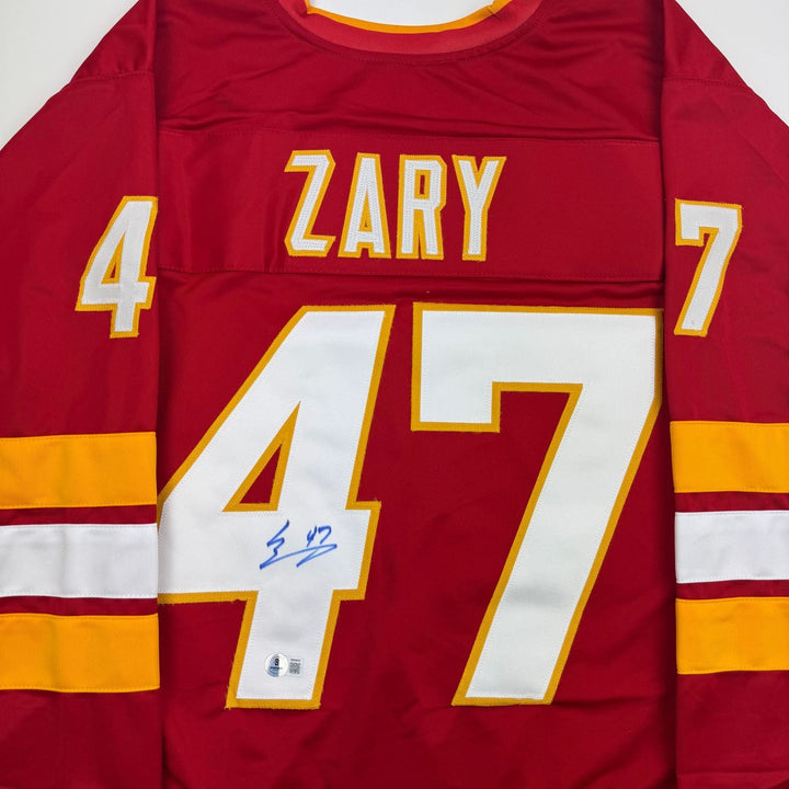 Autographed/Signed Connor Zary Calgary Red Hockey Jersey Beckett BAS COA