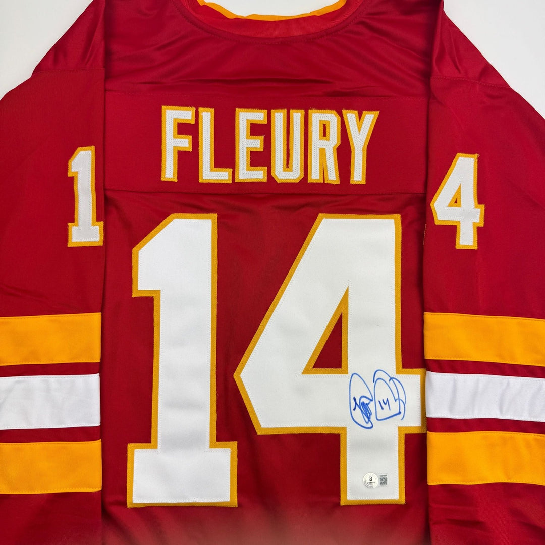Autographed/Signed Theo Fleury Calgary Red Hockey Jersey Beckett BAS COA