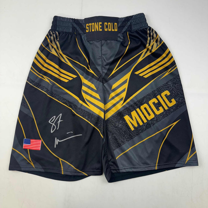 Autographed/Signed Stipe Miocic Black Gold UFC MMA Trunks Shorts BAS COA