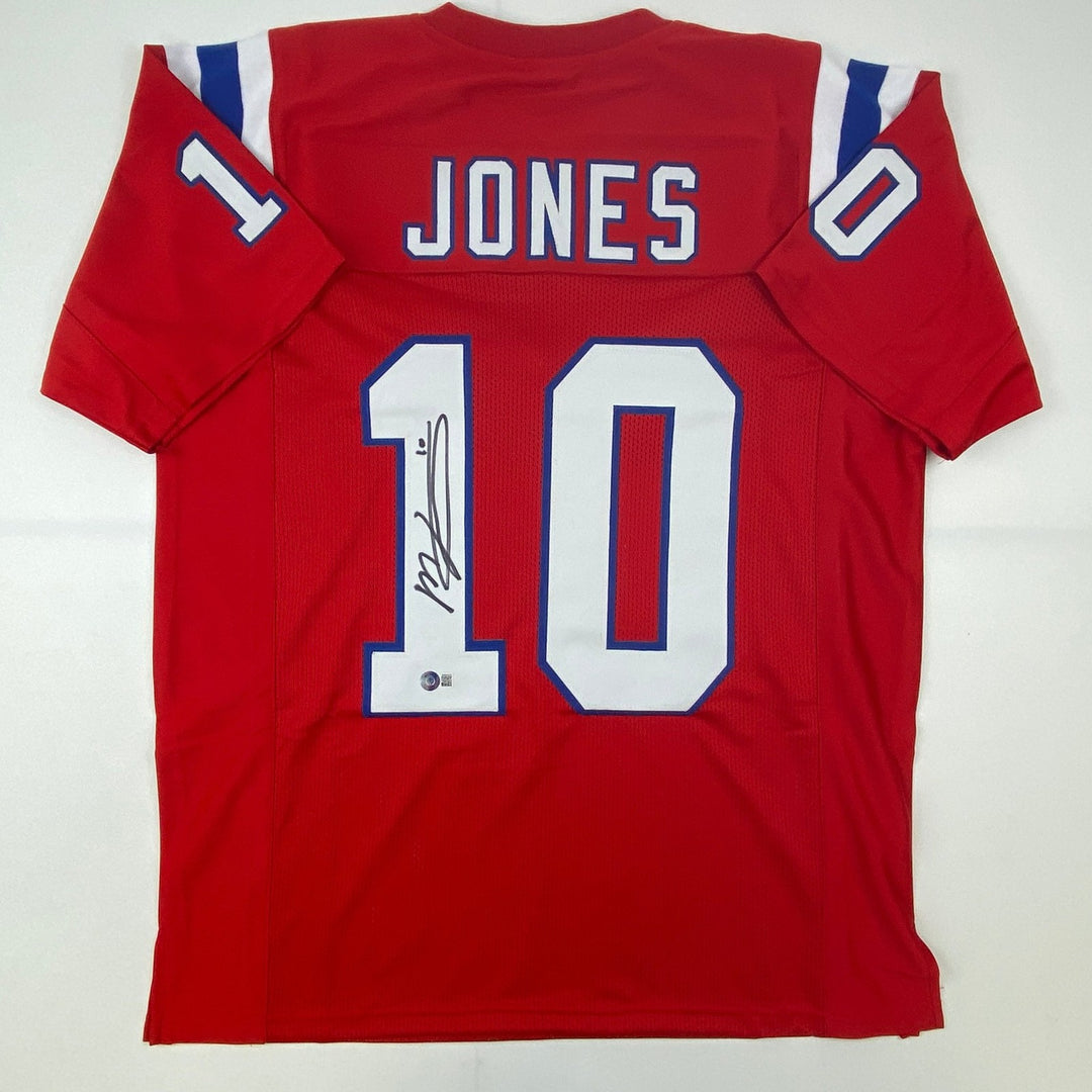 Autographed/Signed Mac Jones New England Red Jersey Beckett BAS COA