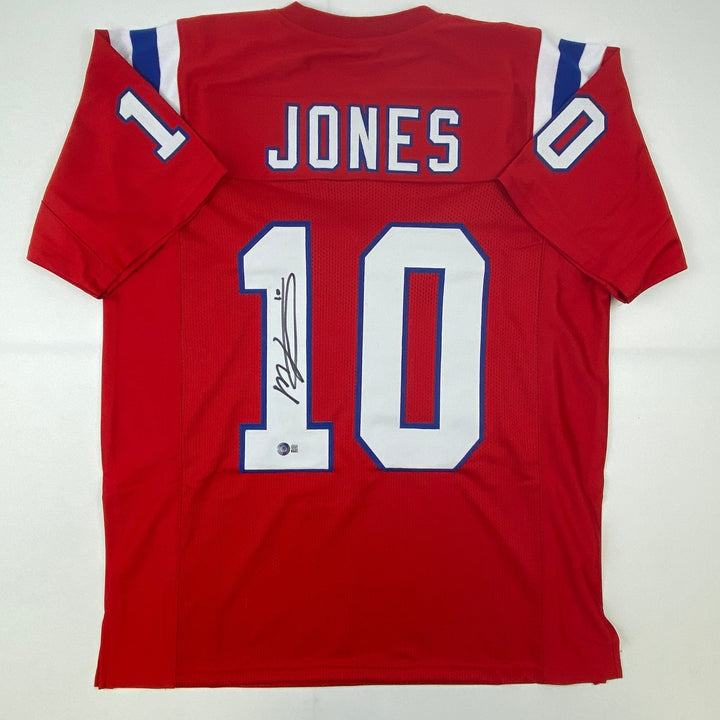 Autographed/Signed Mac Jones New England Red Jersey Beckett BAS COA