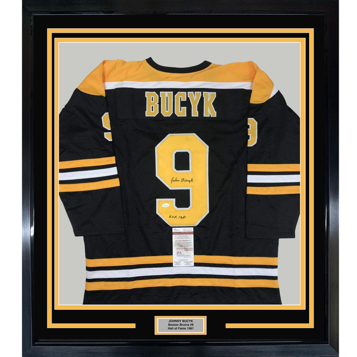 FRAMED Autographed/Signed JOHNNY BUCYK 33x42 Boston Black Hockey Jersey JSA COA