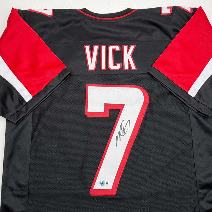 Autographed/Signed MICHAEL MIKE VICK Atlanta Black Jersey PSA/DNA COA