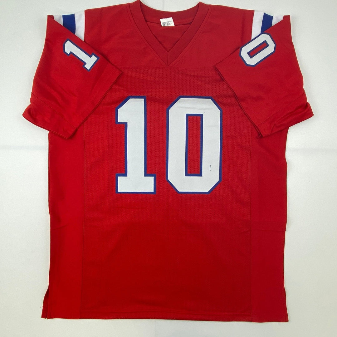 Autographed/Signed Mac Jones New England Red Jersey Beckett BAS COA