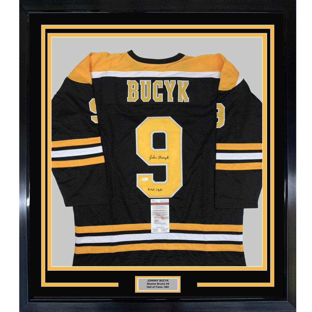 FRAMED Autographed/Signed JOHNNY BUCYK 33x42 Boston Black Hockey Jersey JSA COA