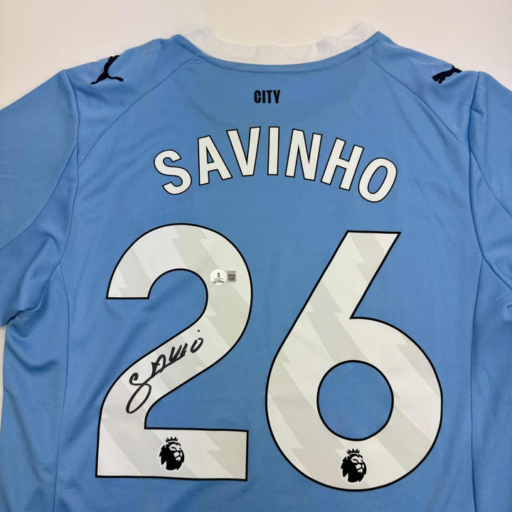 Autographed/Signed Savinho Manchester City Blue Soccer Jersey Beckett BAS COA