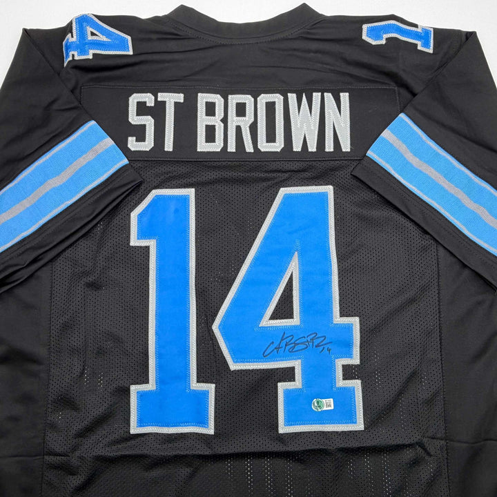 Autographed/Signed Amon-Ra St. Brown Detroit Black Jersey Beckett BAS COA