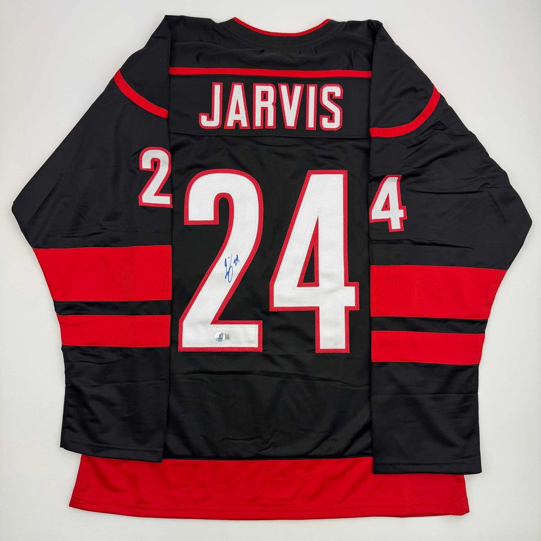 Autographed/Signed Seth Jarvis Carolina Black Hockey Jersey Beckett BAS COA
