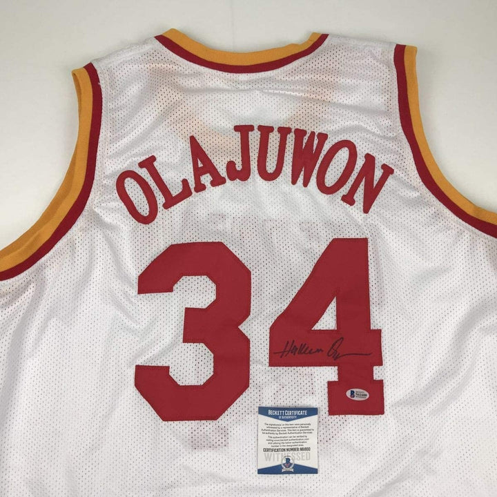 Autographed/Signed Hakeem Olajuwon Houston White Jersey Beckett BAS COA