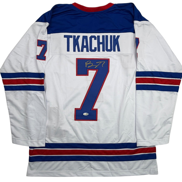 Autographed/Signed Brady Tkachuk USA 2026 Olympics Gold White Jersey JSA COA