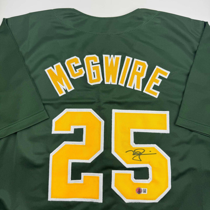 Autographed/Signed Mark McGwire Oakland Green Baseball Jersey Beckett BAS COA